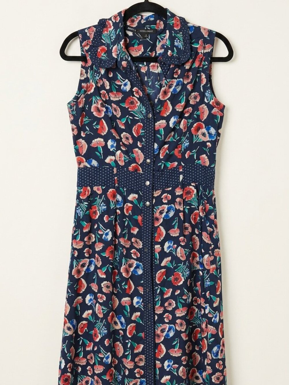 a sleeveless, button-front midi shirt dress
